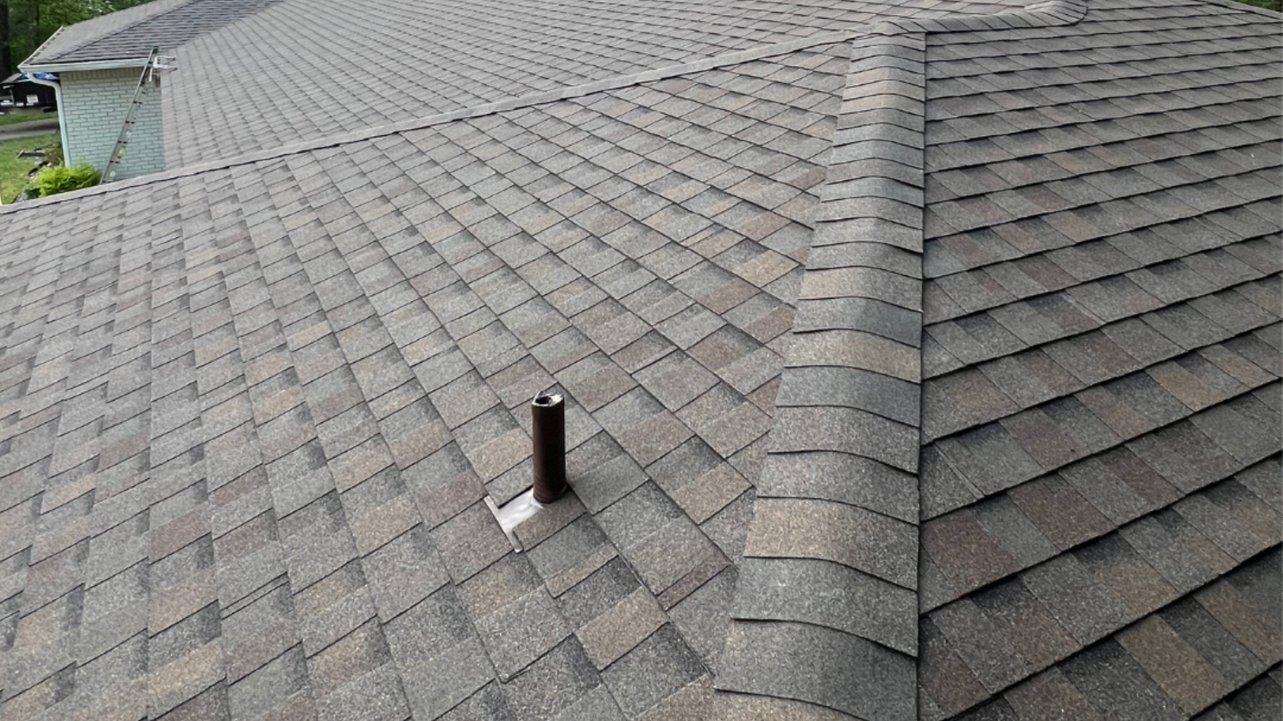 Experienced roofer examining roof structure and flashing with professional tools and safety harness