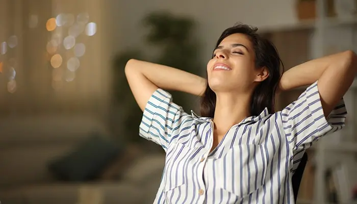 woman taking a deep breath at home